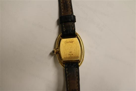 A ladys 18ct gold Cartier oval cased wrist watch, with Cartier box.